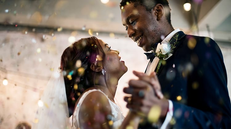 A young couple dances on their wedding day.