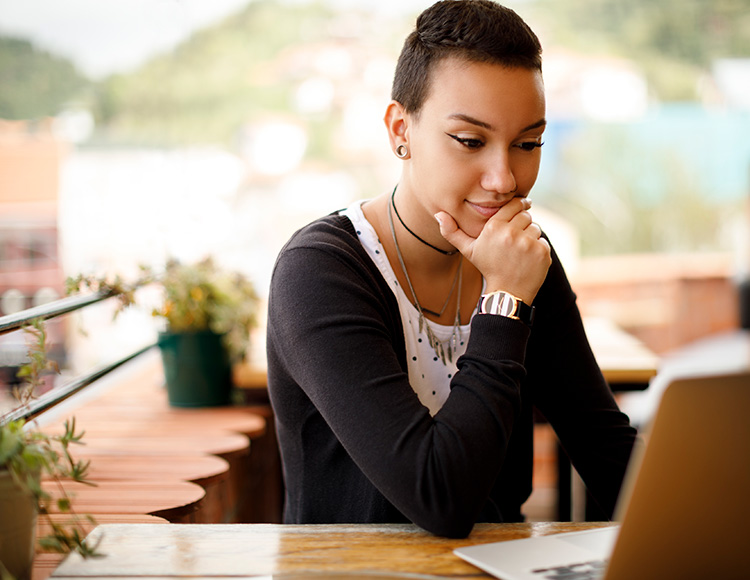 A young woman looks at a computer