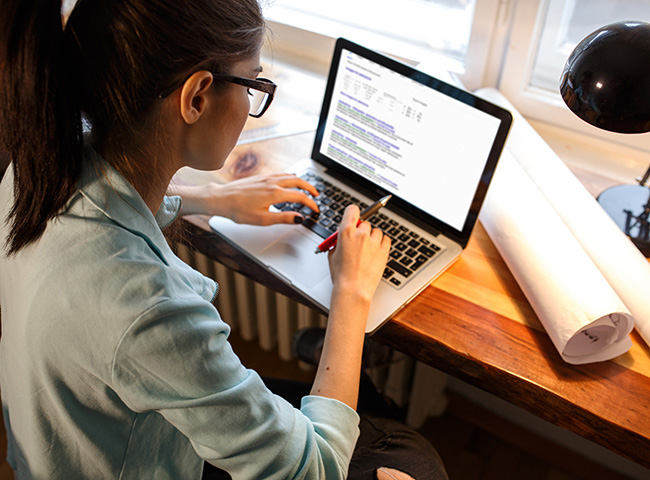 A student uses a laptop to prepare for a virtual career fair.