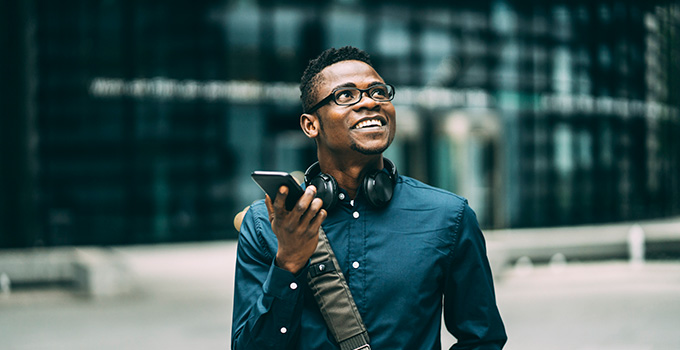 A job seeker walks outside with his phone.